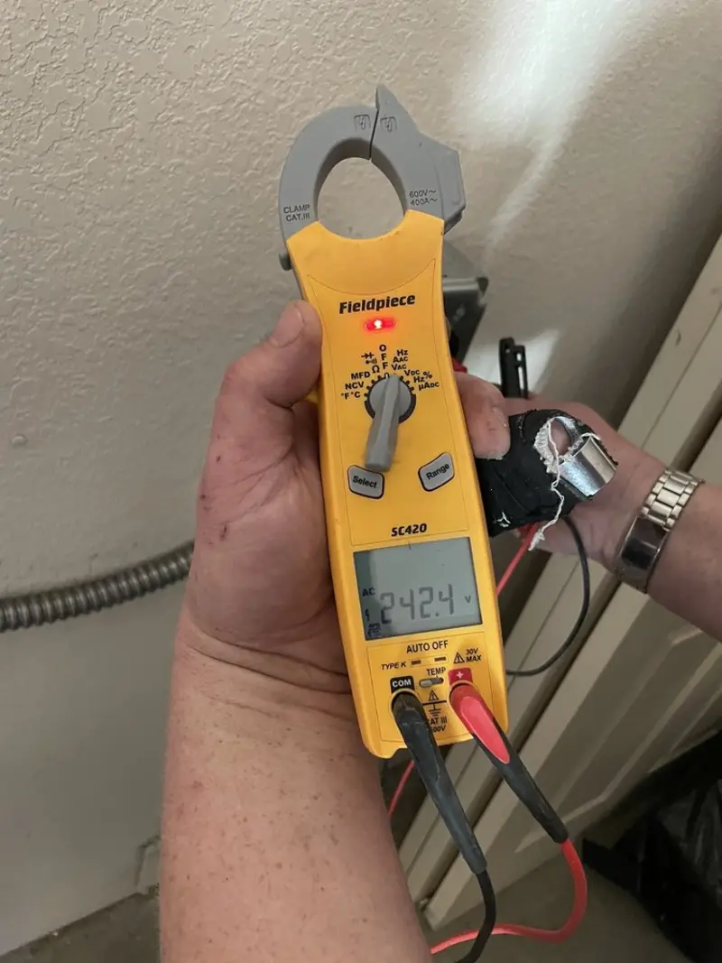 Voltage testing with clamp meter during Outlet Installation in California Polytechnic State University